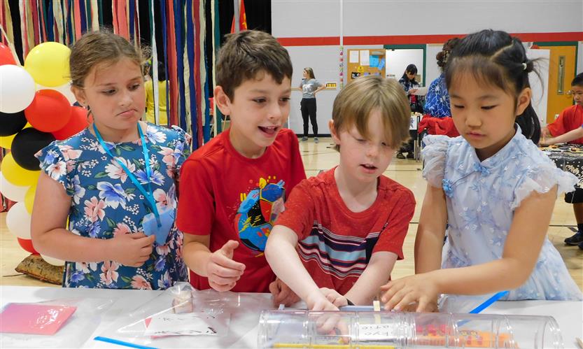 Students smile in the gym while celebrating International Day